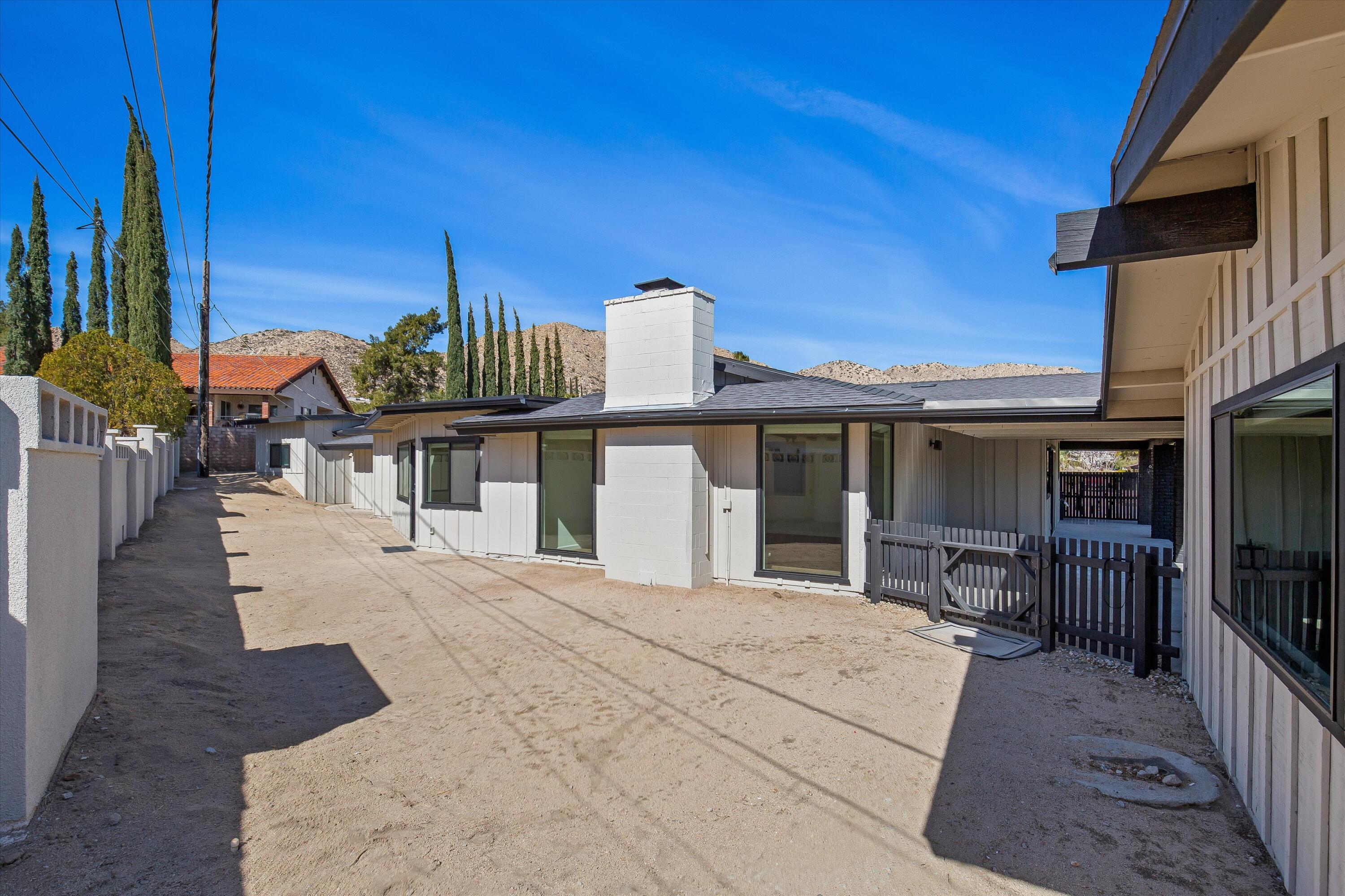 7458 Cardillo Trail Yucca Valley, CA 92284 - Photo 36 of 47 a view of a house with backyard porch and furniture