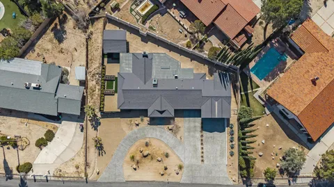 an aerial view of a house with a yard