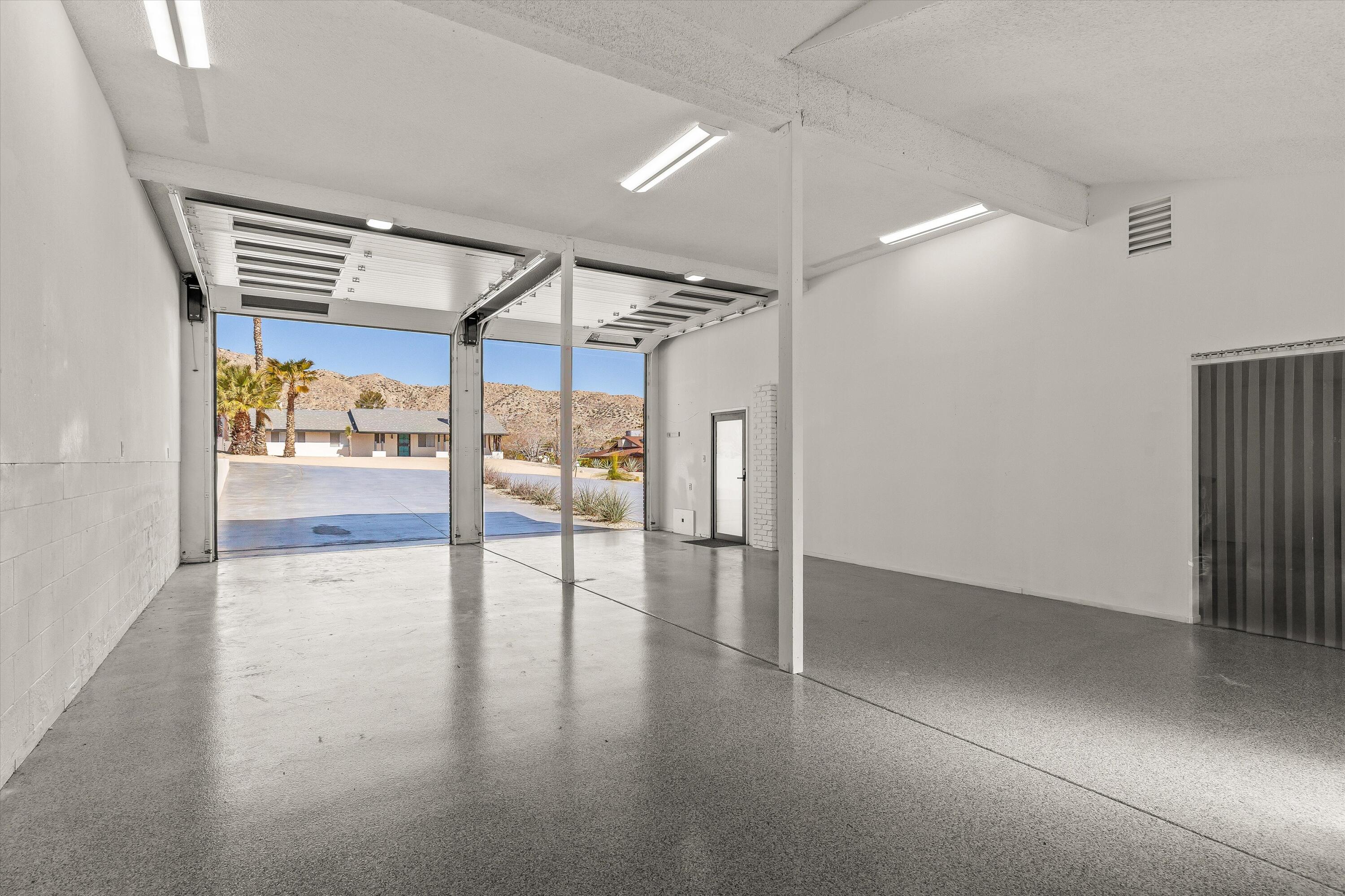 7458 Cardillo Trail Yucca Valley, CA 92284 - Photo 39 of 47 an empty room with wooden floor and windows