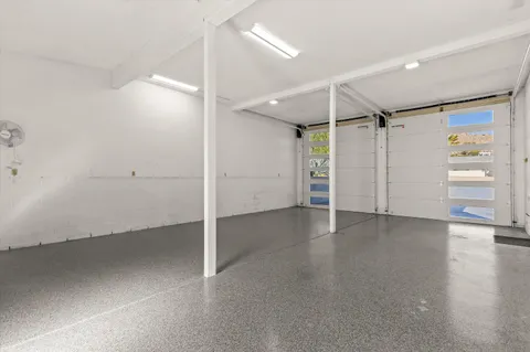 an empty room with closet and windows