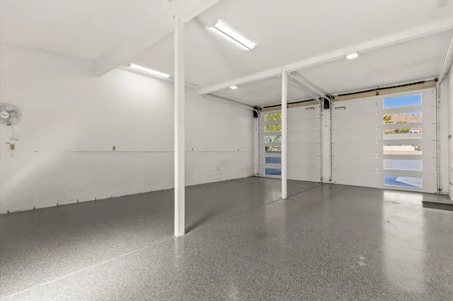 an empty room with closet and windows