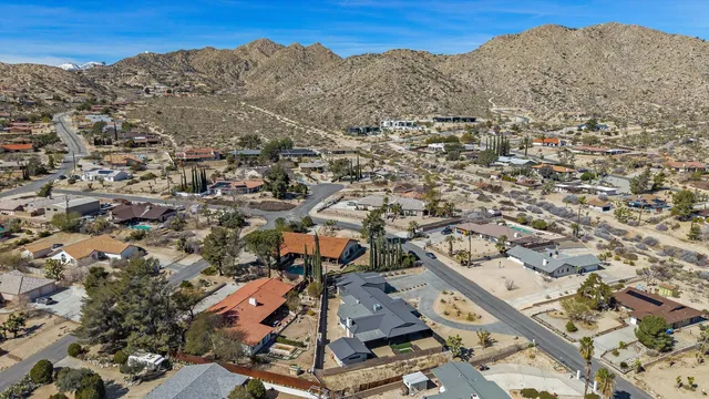an aerial view of residential houses with outdoor space
