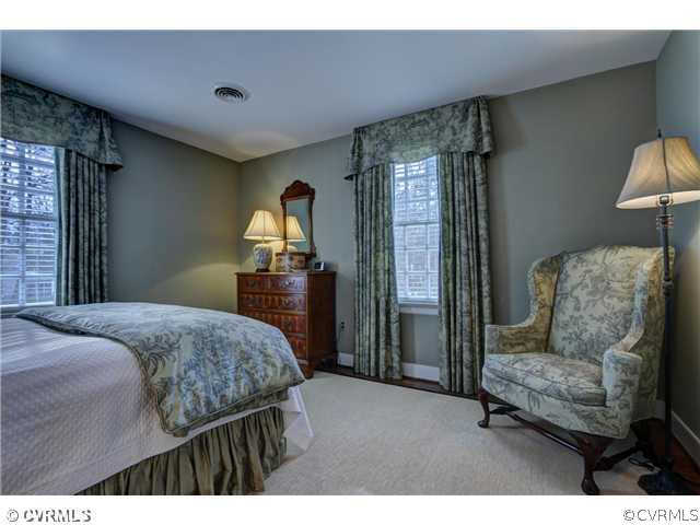2310 Banstead Road Midlothian, VA 23113 - Photo 16 of 21 a bedroom with a bed and dresser with mirror