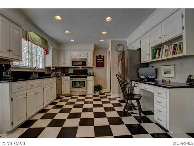 2310 Banstead Road Midlothian, VA 23113 - Photo 7 of 21 a kitchen with a checkered floor and white cabinets