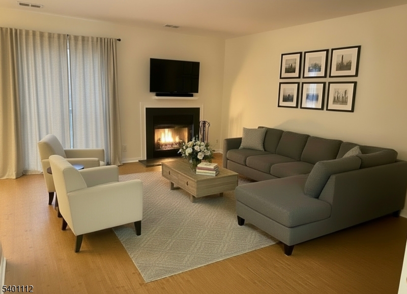 71 Sage Court, Unit 71 Bedminster, NJ 07921 - Photo 1 of 10 a living room with furniture and a fireplace