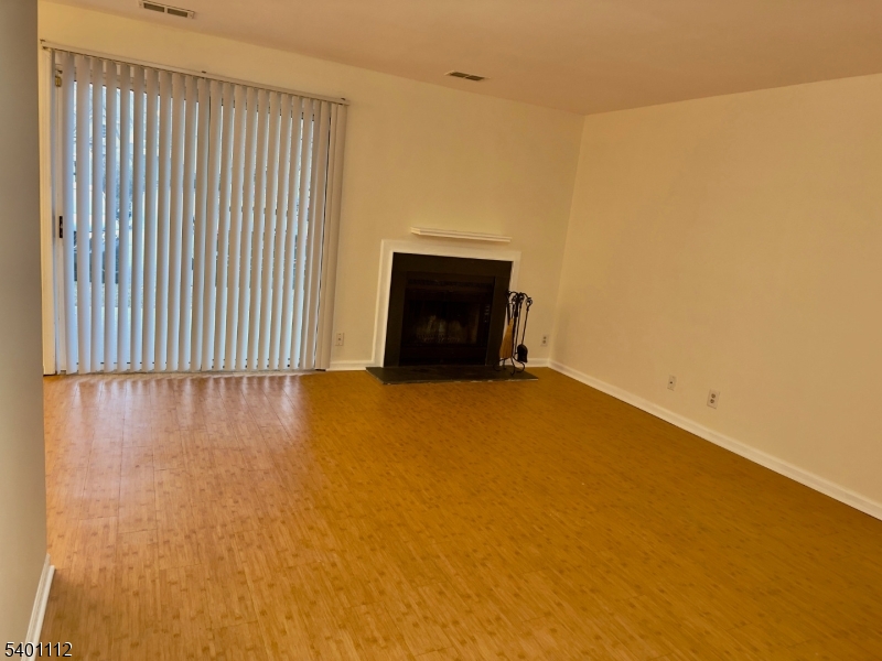 71 Sage Court, Unit 71 Bedminster, NJ 07921 - Photo 2 of 10 a view of an empty room with a fireplace