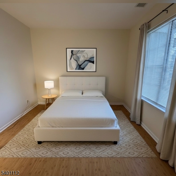 71 Sage Court, Unit 71 Bedminster, NJ 07921 - Photo 9 of 10 a bedroom with a bed and wooden floor