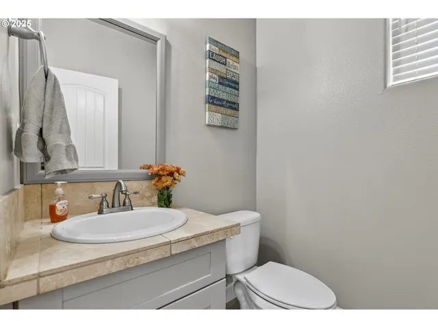 a bathroom with a sink a toilet and mirror