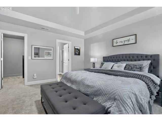 a bedroom with a large bed and a view of bathroom