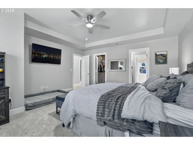 a bedroom with a large bed and a flat screen tv