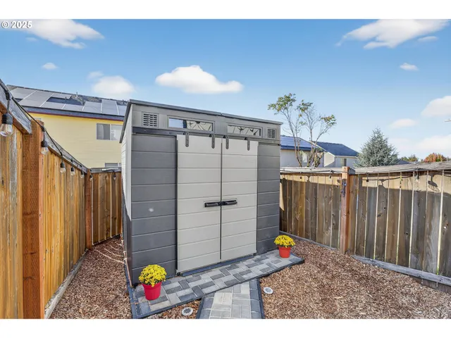 a view of a house with a yard and potted plants