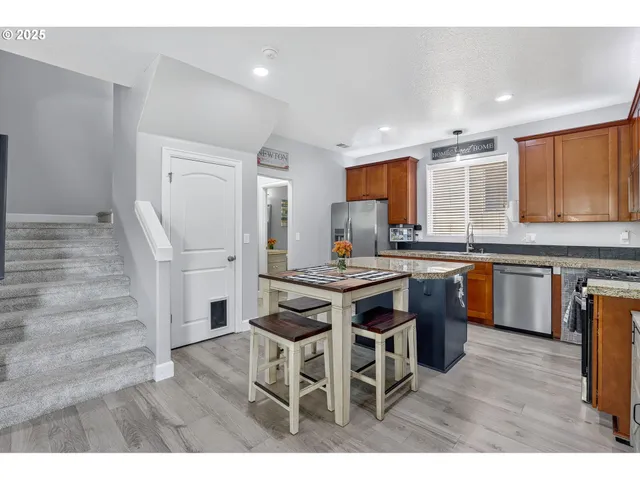 a kitchen with a table chairs sink and cabinets