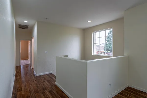a view of hallway with wooden floor