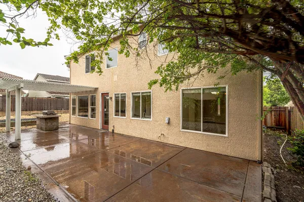 a view of a house with backyard porch and sitting area