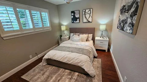 a bed sitting in a bedroom next to a window