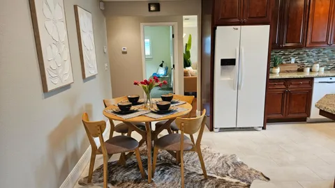 a kitchen with stainless steel appliances a refrigerator and a table