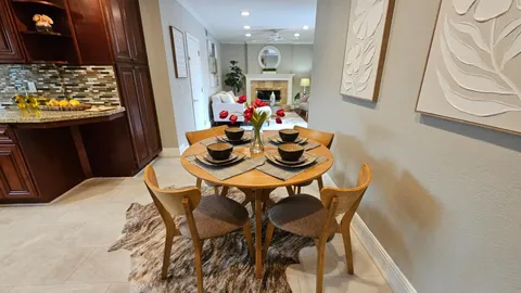 a dining room with furniture and window