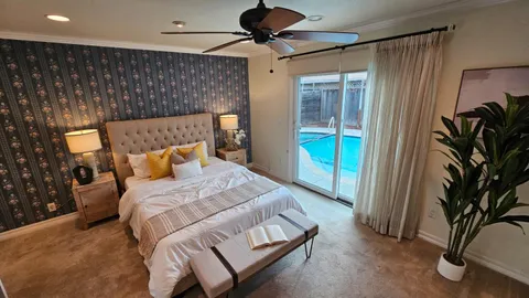 a bedroom with a bed and a chandelier