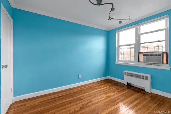 a view of a room with wooden floor and windows