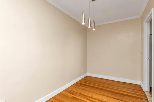 a view of a room with wooden floor