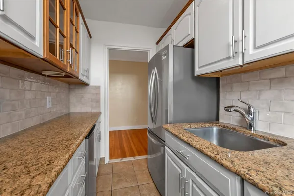 a kitchen with granite countertop sink