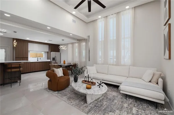 a living room with furniture and kitchen view