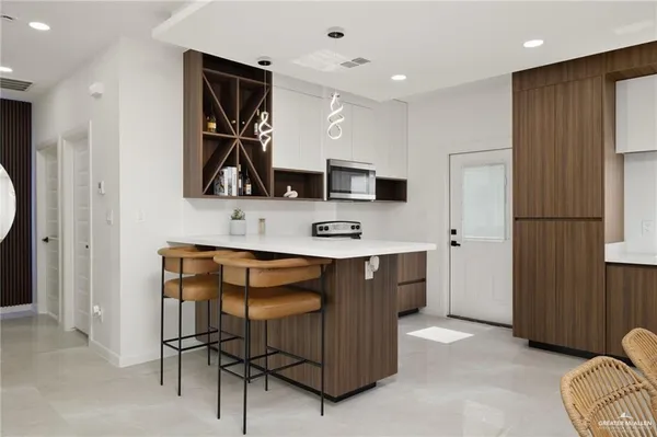 a kitchen with stainless steel appliances granite countertop a refrigerator and a sink