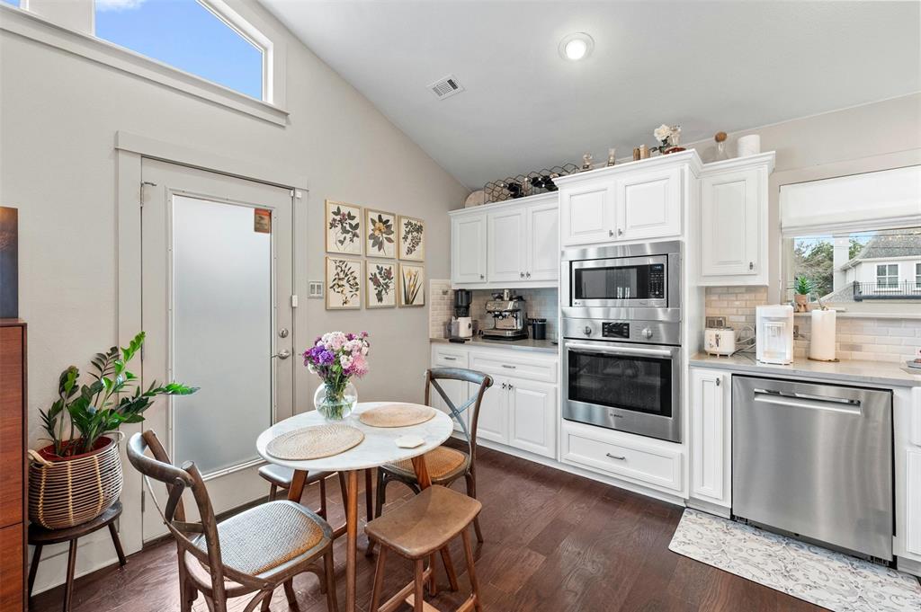 2802 Warren Street, Unit A Austin, TX 78703 - Photo 12 of 29 a kitchen with stainless steel appliances a white table and chairs in it
