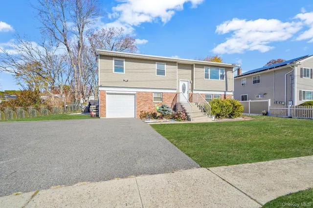 a view of kitchen with granite countertop stove top oven and refrigerator