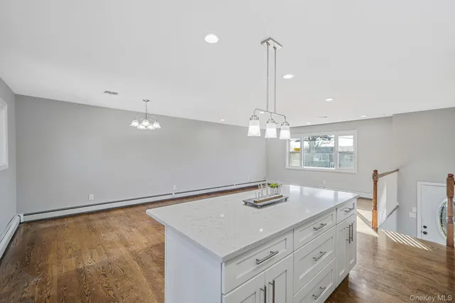 a view of a hallway with wooden floor and entryway