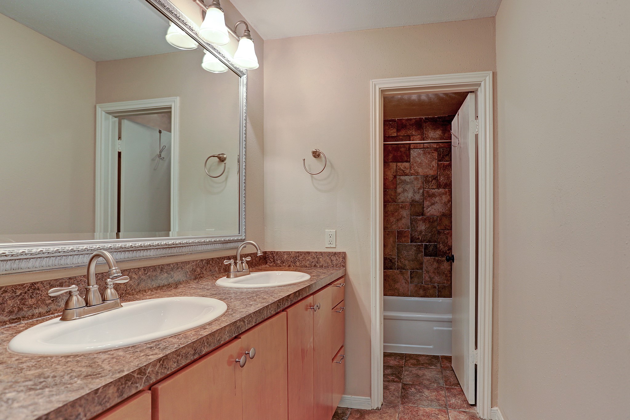 1201 McDuffie Street, Unit 207 Houston, TX 77019 - Photo 13 of 13 a bathroom with a granite countertop sink and a mirror