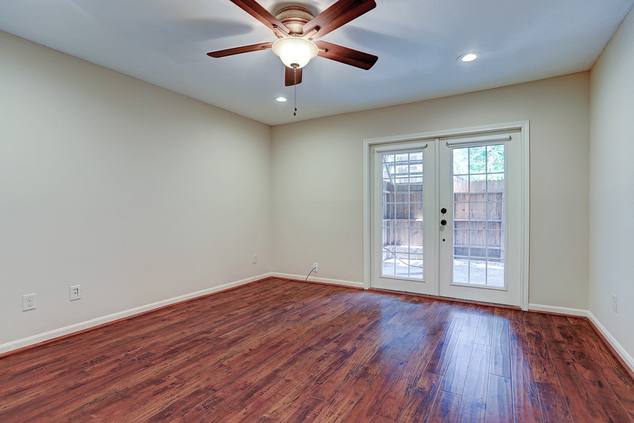 1201 McDuffie Street, Unit 207 Houston, TX 77019 - Photo 3 of 13 an empty room with wooden floor and windows