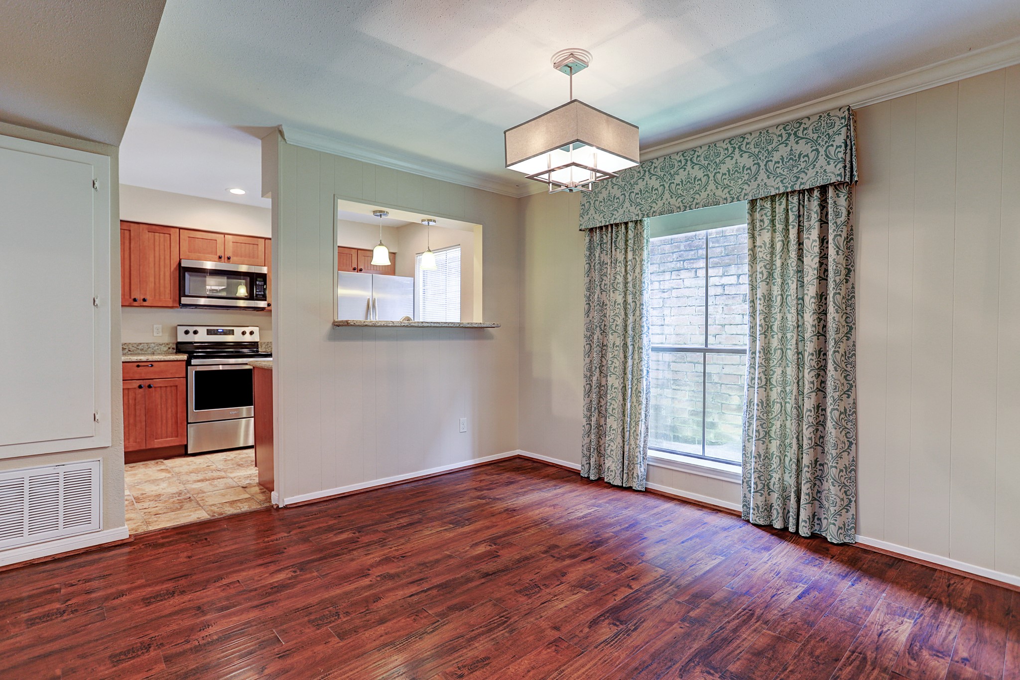 1201 McDuffie Street, Unit 207 Houston, TX 77019 - Photo 6 of 13 an empty room with wooden floor closet and windows
