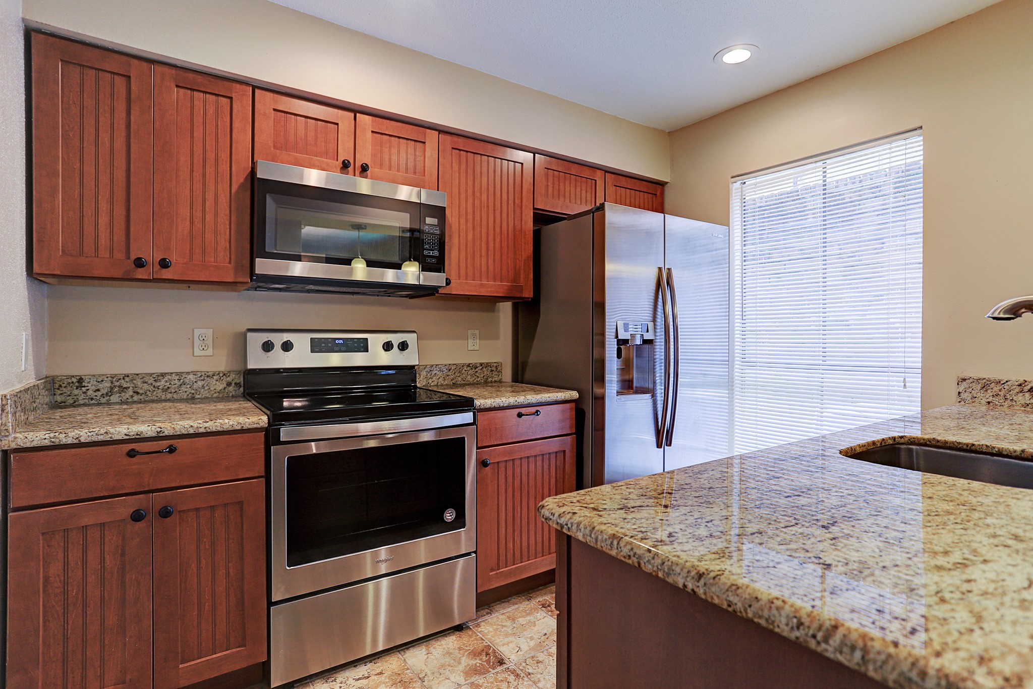 1201 McDuffie Street, Unit 207 Houston, TX 77019 - Photo 7 of 13 a kitchen with stainless steel appliances granite countertop a stove microwave and refrigerator