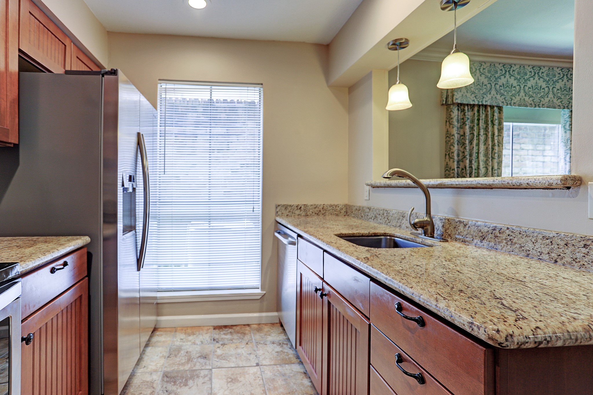 1201 McDuffie Street, Unit 207 Houston, TX 77019 - Photo 8 of 13 a kitchen with a granite countertop sink and refrigerator