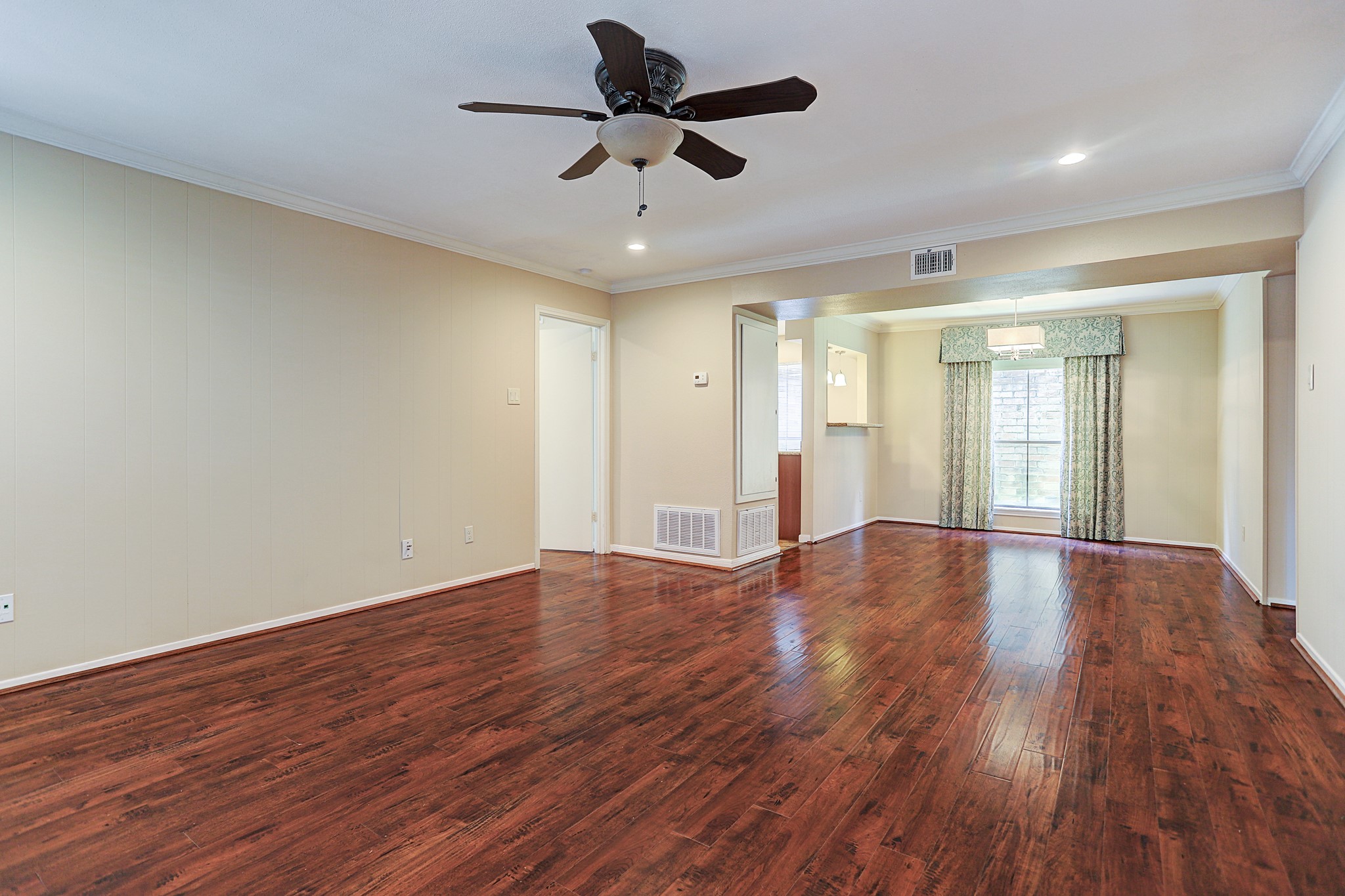 1201 McDuffie Street, Unit 207 Houston, TX 77019 - Photo 10 of 13 a view of an empty room with wooden floor and a window