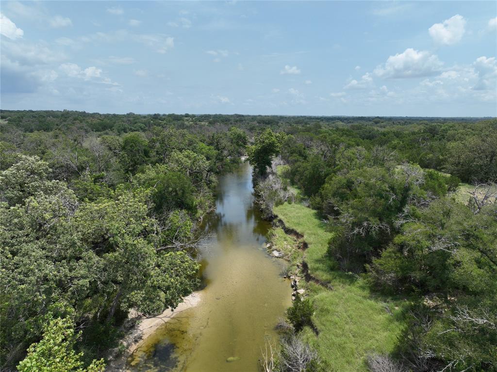 281 Highway 281, Unit O281S Evant, TX 76525 - Photo 10 of 36 Aerial view of property's location featuring a forest and a large body of water