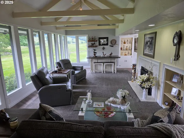 a living room with furniture and a floor to ceiling window