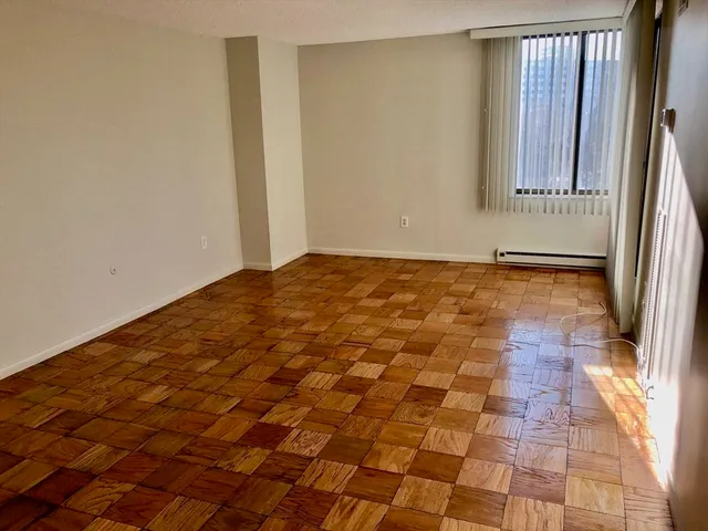 a view of a room with a wooden floor and a window