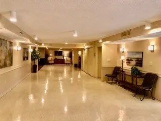 a lobby with furniture and a mirror
