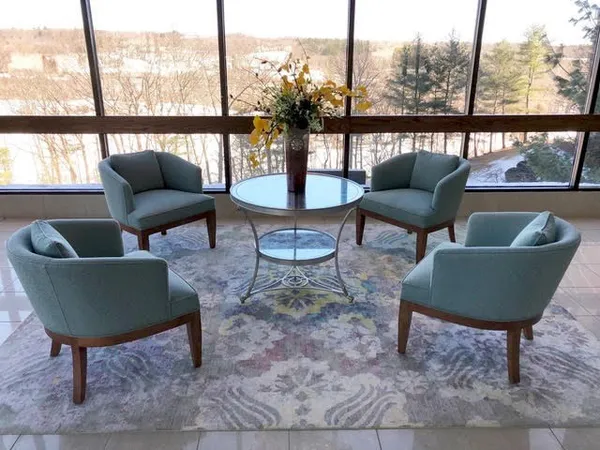 a living room with furniture and a floor to ceiling window