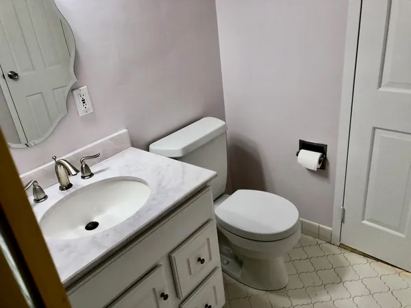 a bathroom with a sink toilet and a mirror