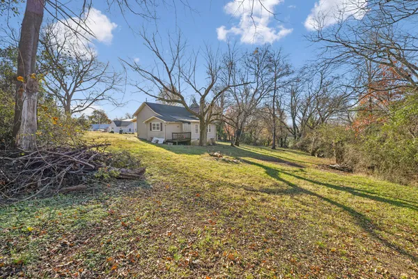 a view of a house with backyard and sitting area