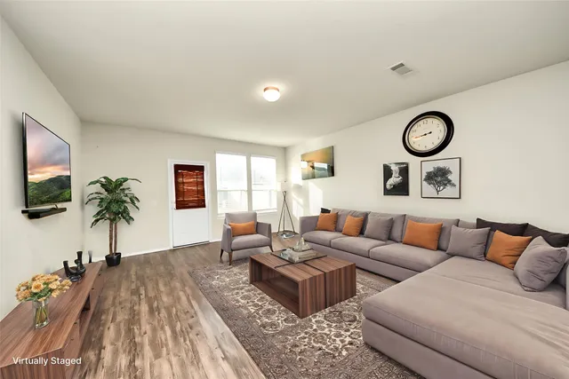a living room with furniture and a flat screen tv