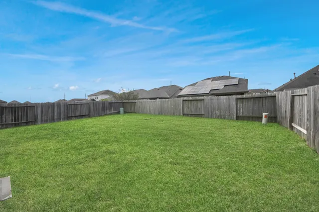 a view of a backyard with a large tree