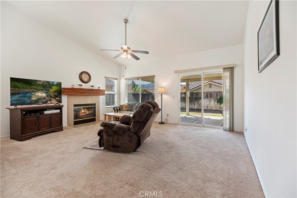 2664 Hazy Way Banning, CA 92220 - Photo 13 of 56 a living room with furniture a fireplace and a flat screen tv
