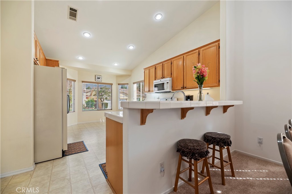 2664 Hazy Way Banning, CA 92220 - Photo 17 of 56 a kitchen with stainless steel appliances granite countertop a refrigerator and a stove top oven