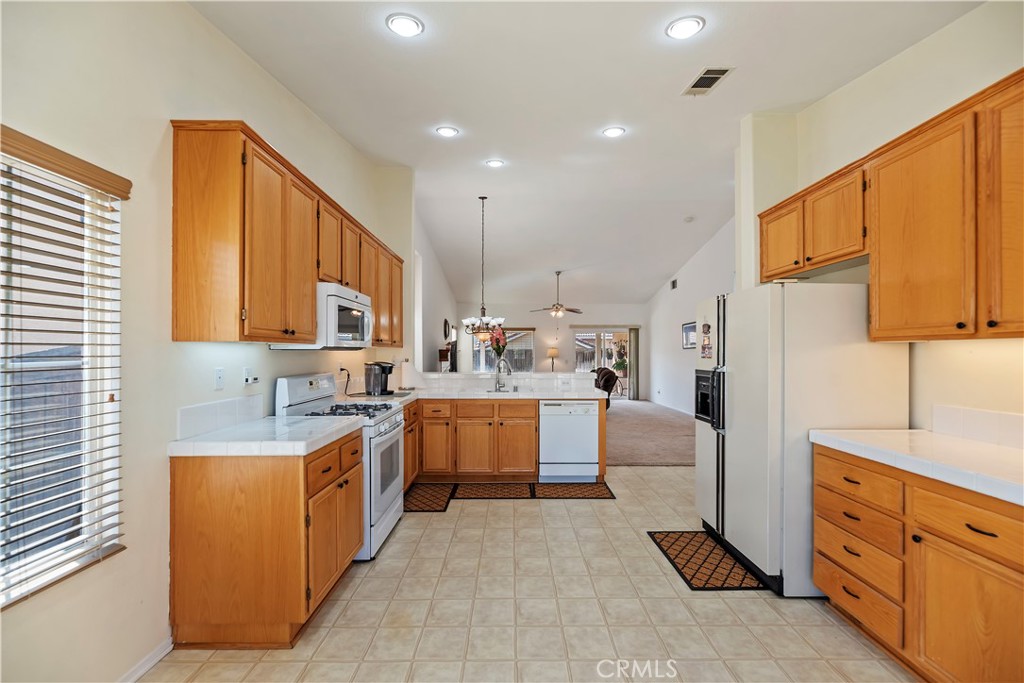 2664 Hazy Way Banning, CA 92220 - Photo 19 of 56 a kitchen with cabinets a sink and white appliances
