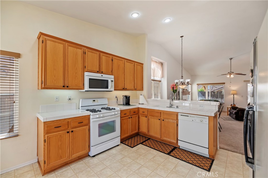 2664 Hazy Way Banning, CA 92220 - Photo 20 of 56 a kitchen with a sink stove and cabinets