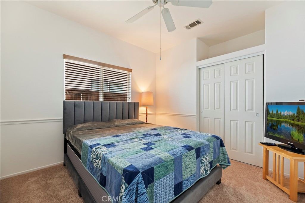 2664 Hazy Way Banning, CA 92220 - Photo 24 of 56 a bedroom with a bed and a flat screen tv